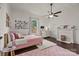 Cozy bedroom with a ceiling fan, a fireplace, and a pink bed at 110 College St, Marshville, NC 28103