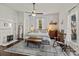 Bright bedroom with a large window, ceiling fan, decorative rug, and cozy seating area at 110 College St, Marshville, NC 28103