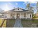 Inviting exterior showcasing a charming home with a covered front porch and stone pathway at 110 College St, Marshville, NC 28103