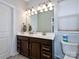 Double vanity bathroom with dark brown cabinets at 11307 Miller Rd # 101, Pineville, NC 28134