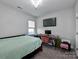 Spacious bedroom with a desk and a large bed at 11307 Miller Rd # 101, Pineville, NC 28134