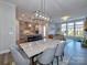 Open concept dining area with marble table and modern chandelier at 11307 Miller Rd # 101, Pineville, NC 28134