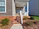 Inviting front porch with brick steps and white railing at 11307 Miller Rd # 101, Pineville, NC 28134