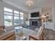 Cozy living room featuring a stone fireplace and large windows at 11307 Miller Rd # 101, Pineville, NC 28134