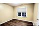 Simple bedroom with hardwood floors and window at 14021 Eldon Dr, Charlotte, NC 28277