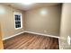 Simple bedroom with wood-look floors and neutral walls at 14021 Eldon Dr, Charlotte, NC 28277