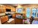 Kitchen with island, wood cabinets, granite countertops, and stainless steel appliances at 14021 Eldon Dr, Charlotte, NC 28277