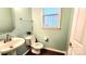 Powder room with pedestal sink and light green walls at 14021 Eldon Dr, Charlotte, NC 28277