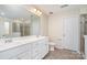 Elegant bathroom with dual sinks, a large mirror, and a spacious shower at 1878 Sapphire Meadow Dr, Fort Mill, SC 29715