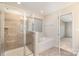 Bathroom with shower and tub, neutral tile, and modern fixtures at 1878 Sapphire Meadow Dr, Fort Mill, SC 29715