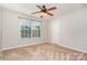 Simple bedroom with neutral carpeting and ceiling fan at 1878 Sapphire Meadow Dr, Fort Mill, SC 29715