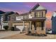 Two-story brick home with gray accents, a two-car garage, and a landscaped yard at 1878 Sapphire Meadow Dr, Fort Mill, SC 29715