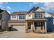 Two-story brick home with gray accents, a two-car garage, and a landscaped yard at 1878 Sapphire Meadow Dr, Fort Mill, SC 29715