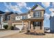 Two-story brick home with gray accents, a two-car garage, and a landscaped yard at 1878 Sapphire Meadow Dr, Fort Mill, SC 29715