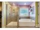 Modern bathroom with a shower and bathtub, updated fixtures at 3001 Burton Point Ct, Waxhaw, NC 28173