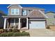 Two-story brick home with a front porch and two-car garage at 3001 Burton Point Ct, Waxhaw, NC 28173