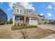 Two-story home with a front porch and attached garage at 3001 Burton Point Ct, Waxhaw, NC 28173