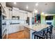 Modern kitchen with island, stainless steel appliances, and hardwood floors at 3001 Burton Point Ct, Waxhaw, NC 28173