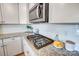 Modern gas cooktop and granite countertops in bright kitchen at 3001 Burton Point Ct, Waxhaw, NC 28173