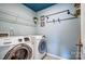 Bright laundry room, featuring washer, dryer, and ample shelving at 3001 Burton Point Ct, Waxhaw, NC 28173