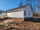 Rear view of a new home showcasing vinyl siding and brick foundation at 301 Cornelius Dr, Rock Hill, SC 29730