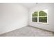 Simple bedroom with grey carpet and a window at 3118 Amay James Ave, Charlotte, NC 28208