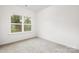 Empty bedroom with grey carpet and a window at 3118 Amay James Ave, Charlotte, NC 28208