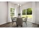 Charming dining area with glass table and chairs, adjacent to sliding doors at 3118 Amay James Ave, Charlotte, NC 28208