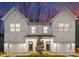 Modern two-unit building with white siding, attached garages, and landscaping at 3118 Amay James Ave, Charlotte, NC 28208