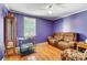 Purple bedroom with hardwood floors and a comfortable couch at 3524 Lancaster Hwy, Monroe, NC 28112