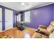 Spacious bedroom with hardwood floors, purple walls, and ample natural light at 3524 Lancaster Hwy, Monroe, NC 28112