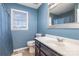 Bathroom with dark vanity and blue walls at 410 E Louisiana Ave # 2, Bessemer City, NC 28016