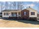 Brick ranch house with a yellow exterior, covered porch, and landscaped yard at 410 E Louisiana Ave # 2, Bessemer City, NC 28016