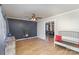 Living room with dark gray accent wall, hardwood floors, and a view into dining area at 410 E Louisiana Ave # 2, Bessemer City, NC 28016