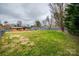 Large grassy backyard with a storage shed and a full, wooden privacy fence at 4328 Hancock Ter, Charlotte, NC 28205