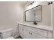 Modern bathroom featuring white vanity with quartz counters and a decorative mirror at 4328 Hancock Ter, Charlotte, NC 28205