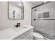 Modern bathroom with glass enclosed shower, sleek fixtures and quartz counters at 4328 Hancock Ter, Charlotte, NC 28205