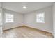 Well-lit bedroom with hardwood floors and dual windows overlooking the neighborhood at 4328 Hancock Ter, Charlotte, NC 28205