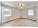 Well-lit bedroom with hardwood floors and dual windows overlooking the backyard at 4328 Hancock Ter, Charlotte, NC 28205