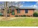 Charming brick home with a green front door and well-maintained lawn at 4328 Hancock Ter, Charlotte, NC 28205