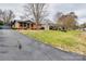 Charming single-Gathering home boasts a brick facade, tidy landscaping, and a large front yard at 4328 Hancock Ter, Charlotte, NC 28205