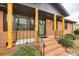 Inviting front porch with brick steps and decorative wood pillars at 4328 Hancock Ter, Charlotte, NC 28205