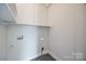 This laundry room boasts new shelving, ample space, and crisp white walls at 4328 Hancock Ter, Charlotte, NC 28205