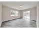 Spacious living room with tile floors, large windows, and sliding glass doors leading to the backyard at 4328 Hancock Ter, Charlotte, NC 28205