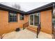 Brick patio with black railings, black-trimmed windows, and glass sliding doors to the backyard at 4328 Hancock Ter, Charlotte, NC 28205