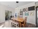 Dining room with a long wooden table, decorative artwork, and sliding doors to the patio at 620 Altamonte Dr, Clover, SC 29710