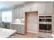 Kitchen with gray cabinets, white countertops, and double ovens at 9931 Cask Way, Huntersville, NC 28078