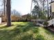 Expansive backyard featuring a large lawn, privacy fence, and a dining patio at 1012 Rockway Dr, Charlotte, NC 28205