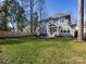 Spacious backyard with lush green grass, patio dining, and exterior home view at 1012 Rockway Dr, Charlotte, NC 28205