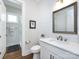 Well-lit bathroom with white vanity, quartz countertop, and modern fixtures at 1012 Rockway Dr, Charlotte, NC 28205